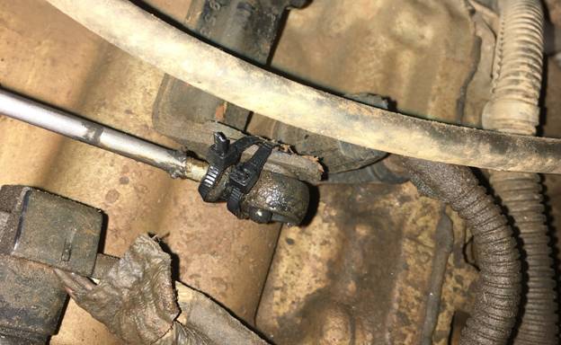 With two zip ties holding my transmission shifter linkage to the transmission lever, it was time to replace the bushing